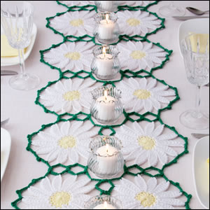 Large daisy motifs in medium weight yarn make this runner quick to